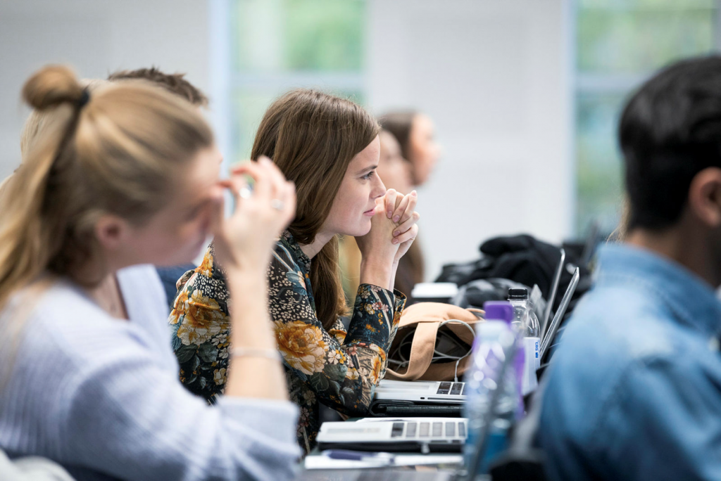 Students looking into computer