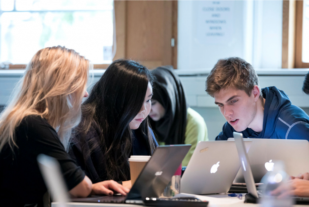 Group of students looking at a computer